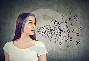 Woman talking with alphabet letters coming out of her mouth