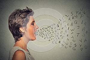 Woman talking with alphabet letters coming out of her mouth