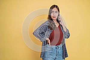 a woman talking on a call using a mobile phone with an angry expression