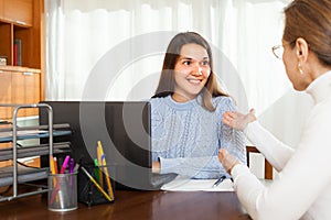 Woman talking with employee at home