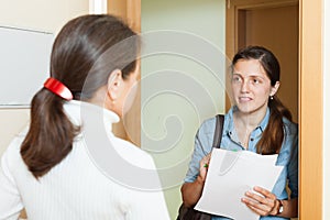 Woman talking with employee with paper