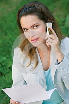 Woman talking by the mobile phone outdoors