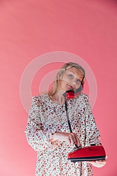 Woman talking on an old wired phone