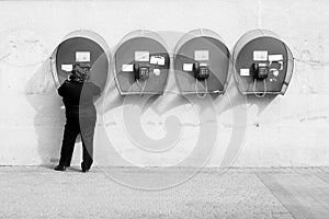 Woman talking on pay phone