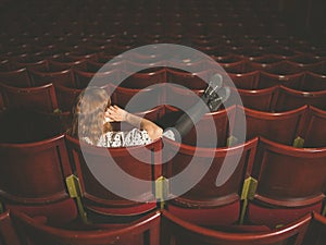 Woman talking on phone in auditorium