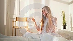Woman talking phone in bed