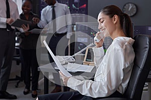 Woman talking on the phone in broking office