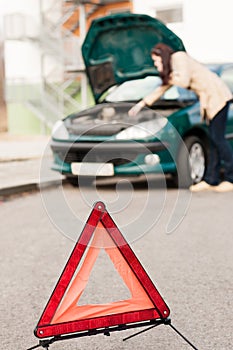 Woman talking on the phone car breakdown