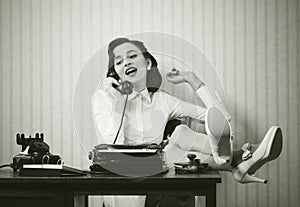 Woman talking on phone at desk