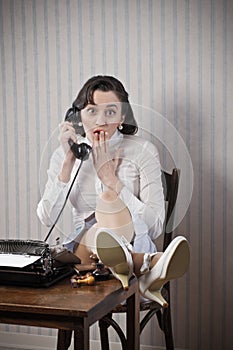 Woman talking on phone at desk