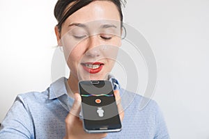 Woman talking on the phone with digital voice assistant