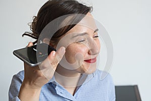 Woman talking on the phone with digital voice assistant