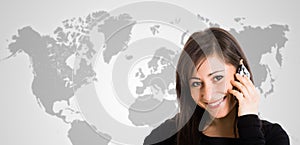 Woman talking on the phone in front of a world map
