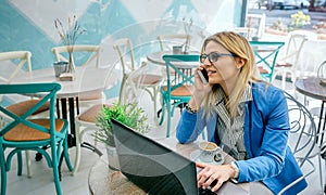 Woman talking on phone with laptop