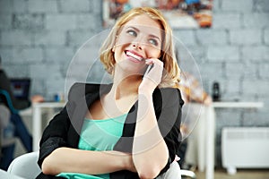 Woman talking on the phone at office