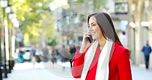 Woman talking on phone in the street in winter
