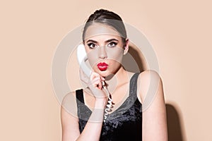 Woman talking on the phone, vintage style. Excited pin up girl, pinup style. Beautiful woman in pin up style with