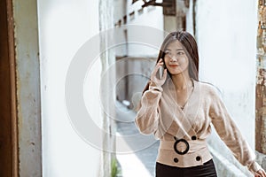 Woman talking on phone while walking in the city