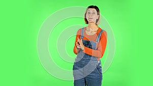 Woman talking and pointing side hand for something, copy space. Green screen