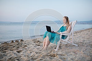 Woman talking skype at the beach photo