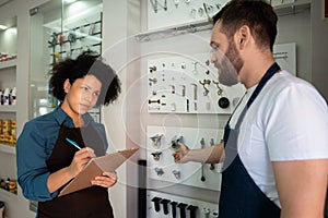 Woman talking to colleague about sales and training at utility store