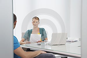 Woman Talking To Cropped Colleague In Office