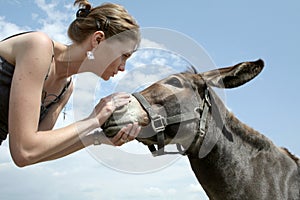 Woman talking to donkey