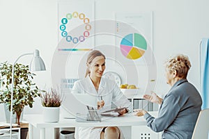 Woman talking to a female doctor at a diet consultation in a privet clinic