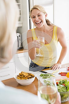 Woman Talking To Friend While Preparing meal