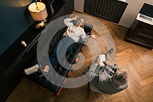 Woman talking to her psychotherapist in his office