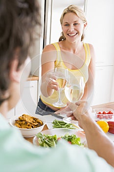 Woman Talking To Husband While Preparing meal