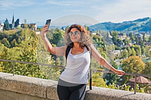 Woman calling for video call in touristic place photo