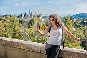 Woman calling for video call in touristic place photo
