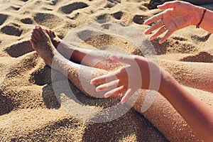 Woman tanned legs on sand beach. Travel concept. Happy feet in tropical paradise.