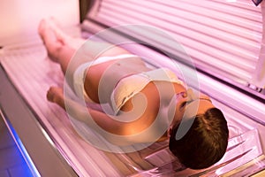 Woman on tanning bed.