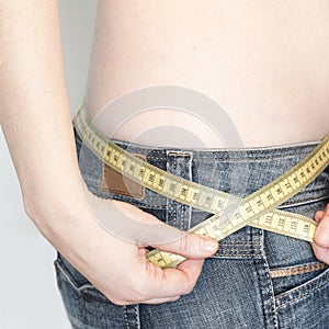 Woman with a tape measure arround her body