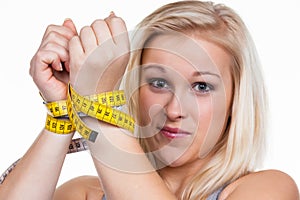 Woman with tape measure before the next diet