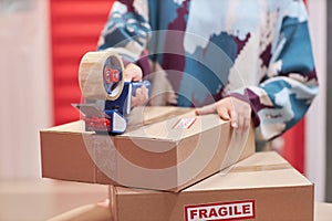 Woman Taping Boxes with Belongings