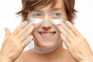 Woman tapping under eye cream