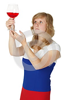 Woman - taster checks color and opacity of wine