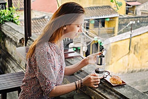 Woman tastes vietnamese coffee