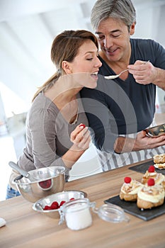 Woman tasting cake preparation