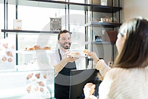 Woman Tasting Choux Offered By Baker