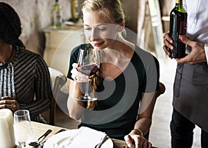 Woman Tasting Red Wine in a Classy Restaurant