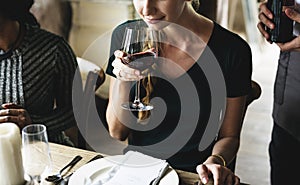 Woman Tasting Red Wine in a Classy Restaurant