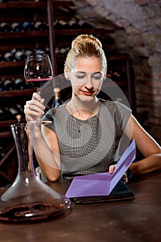 Woman tasting wine in the cellar