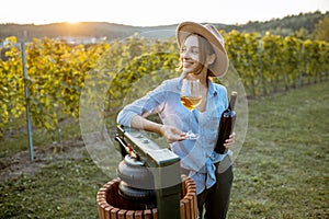 Woman tasting wine on the vineyard