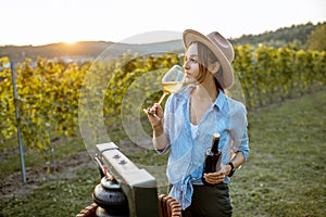 Woman tasting wine on the vineyard