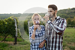 Woman tasting wine in wine grower vineyard