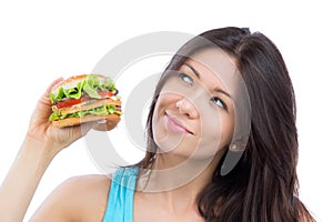 Woman with tasty fast food unhealthy burger in hand to eat